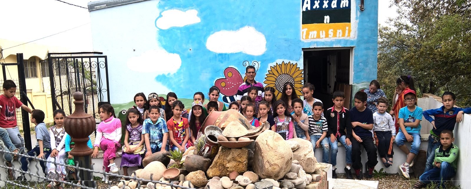 Children in front of the painted House of Knowledge in Kabylia